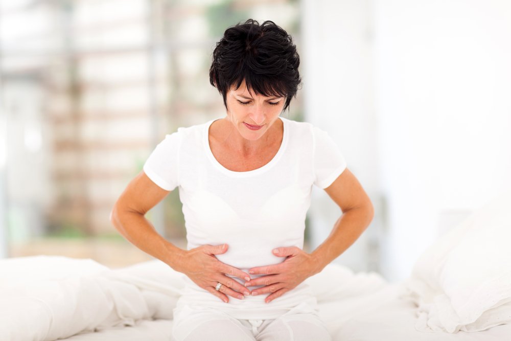 mid age woman having stomach pain